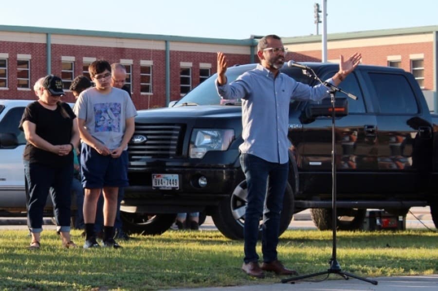 Members of the Magnolia community gathered to pray June 5 for unity amid unrest in the nation. Some gathered on the lawn in front of Magnolia High School while others stayed in their vehicles, listening in via an FM transmitter. (Dylan Sherman/Community Impact Newspaper)
