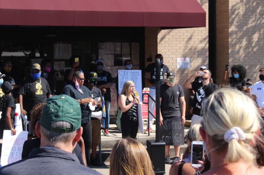 Jessica Seggebruch (center), an organizer of the event, addressed the crowd at City Hall. (Dylan Sherman/Community Impact Newspaper)