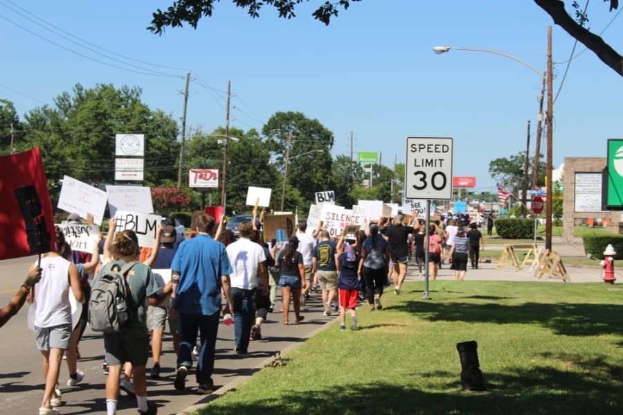 Protesters travel down West Main Street on their way to City Hall on June 13. (Dylan Sherman/Community Impact Newspaper)