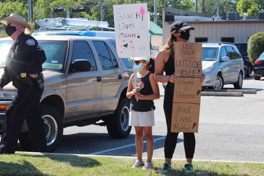A group gathers in front of Tomball City Hall. (Anna Lotz/Community Impact Newspaper)