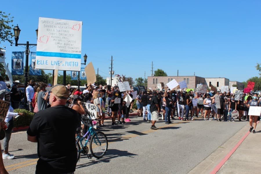 Protesters with varied perspectives peacefully gathered in front of Tomball City Hall on June 13. (Anna Lotz/Community Impact Newspaper)