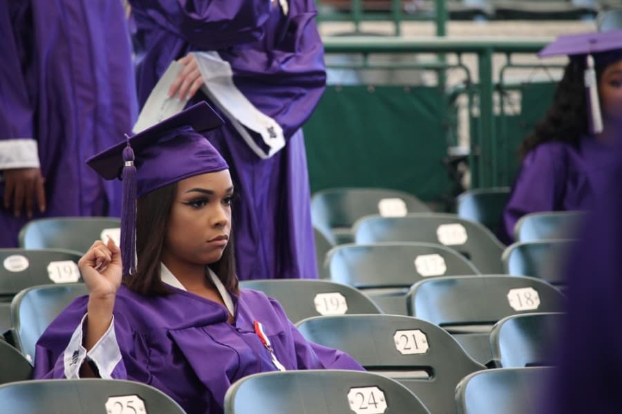 A student raises their fist while sitting through the National Anthem. (Andy Li/Community Impact Newspaper)