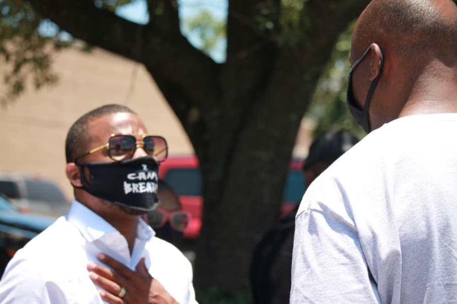 President LaDon Johnson speaking with a protestor. (Andy Li/Community Impact Newspaper)
