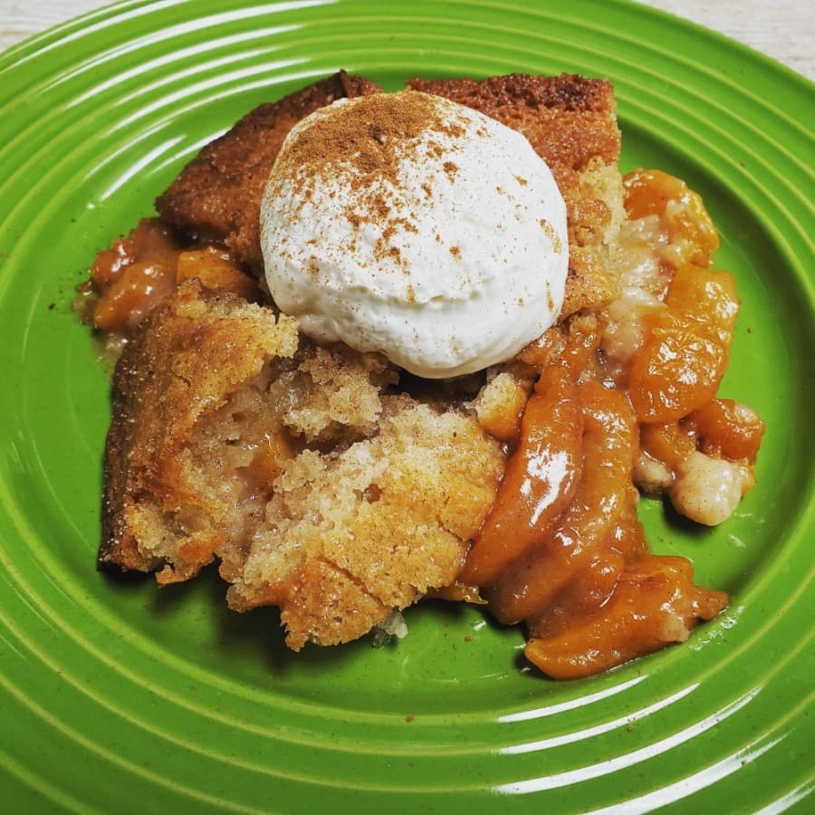 Jacque Guinn's Country Peach Cobbler ($6.50) is served with a homemade cream and cinnamon topping. (Courtesy MiMi J's Kitchen)