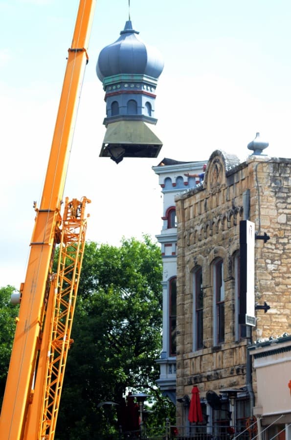 The onion dome on top of the Old Masonic Lodge Building, now Gumbo's North, was removed the morning of June 18. A new but identical dome will replace the old one after repairs to the building's roof are complete. (John Cox/Community Impact Newspaper)