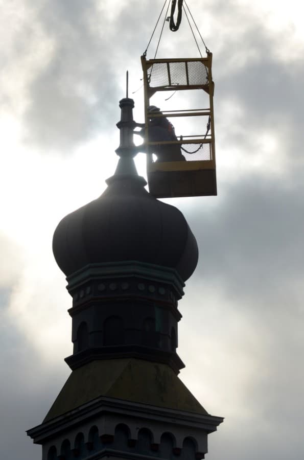 The onion dome on top of the Old Masonic Lodge Building, now Gumbo's North, was removed the morning of June 18. A new but identical dome will replace the old one after repairs to the building's roof are complete. (John Cox/Community Impact Newspaper)