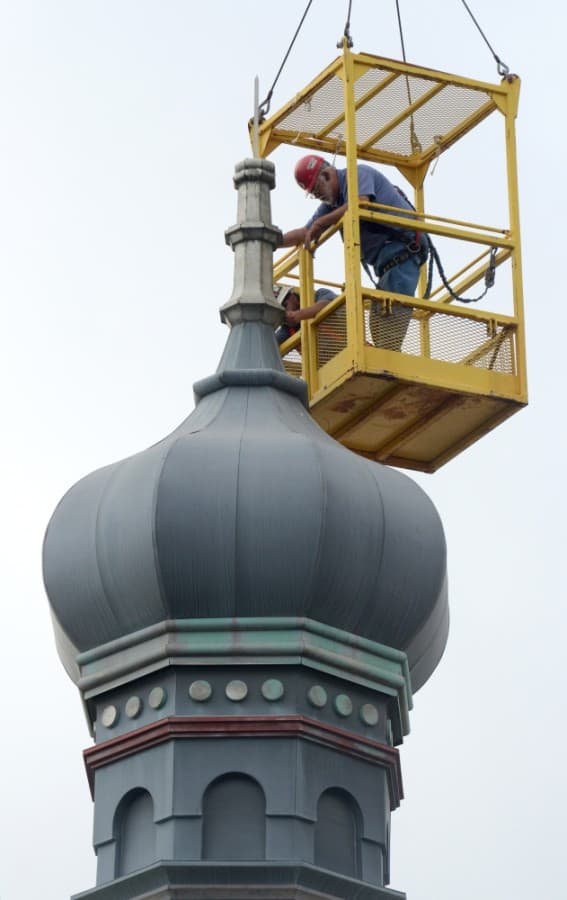 The onion dome on top of the Old Masonic Lodge Building, now Gumbo's North, was removed the morning of June 18. A new but identical dome will replace the old one after repairs to the building's roof are complete. (John Cox/Community Impact Newspaper)