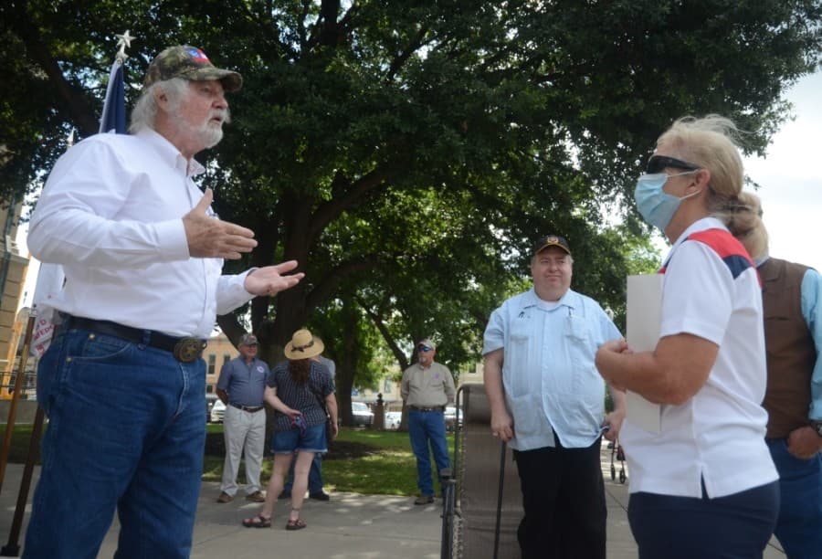 Georgetown resident Shelby Little (left), of the Texas division of the Sons of Confederate Veterans, speaks with Michelle Augustine of Courageous Conversations and the San Gabriel Unitarian Universalist Church, at the conclusion of the protest surrounding the presence of a Confederate soldier statue on the grounds of the Williamson County Courthouse. (John Cox/Community Impact Newspaper)