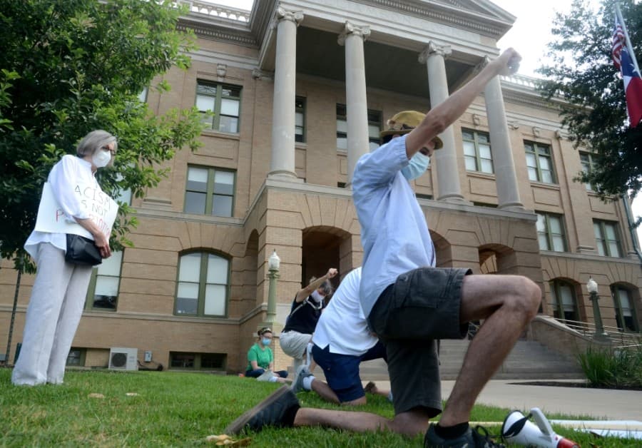 A group of local residents interested in the removal of a Confederate statue from the grounds of the Williamson County Courthouse took a knee and obeyed eight minutes and 46 seconds of silence in remembrance of the death of George Floyd in Minneapolis on May 25. (John Cox/Community Impact Newspaper)