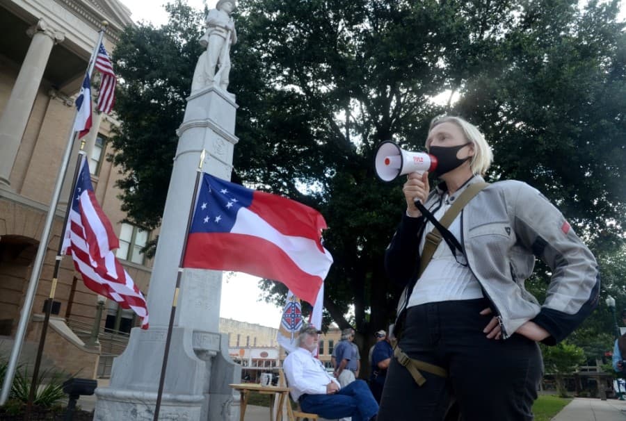 Georgetown resident Lina Terrell of the Northern Williamson County Democrats speaks to a group of about 25 people who want the statue of a Confederate soldier removed from the grounds of the Williamson County Courthouse. (John Cox/Community Impact Newspaper)