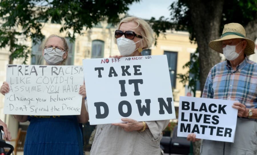 A protest group voiced opinions in favor of removing the Confederate soldier statue from the Williamson County Courthouse grounds June 18. (John Cox/Community Impact Newspaper)