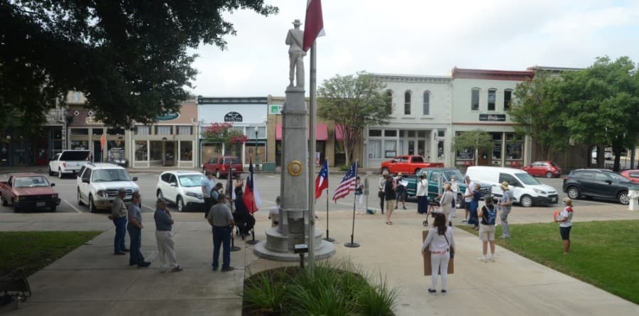 On the left are people in favor of keeping the statue of a Confederate soldier on the grounds of the Williamson County Courthouse; on the right are people in favor of moving the statue to another location. (John Cox/Community Impact Newspaper)