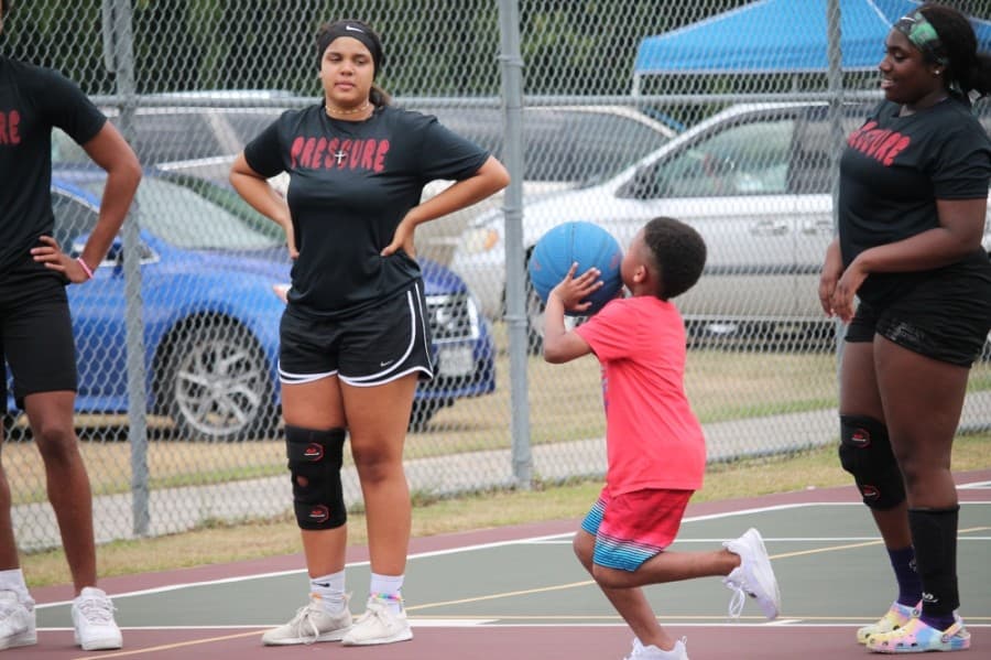 A child shoots a basketball at Dr. Martin Luther King Jr. Park. (Andy Li/Community Impact Newspaper)