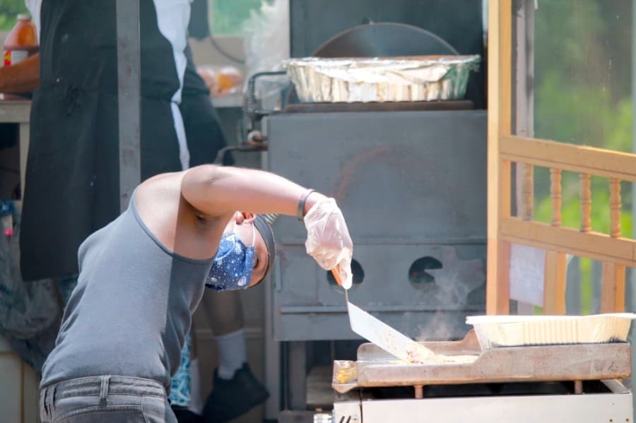 An attendee checks a burger. (Andy Li/Community Impact Newspaper)