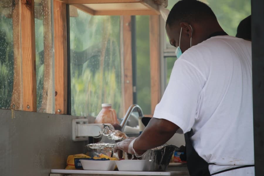 A man prepares food during the Juneteenth celebration in Conroe. (Andy Li/Community Impact Newspaper)