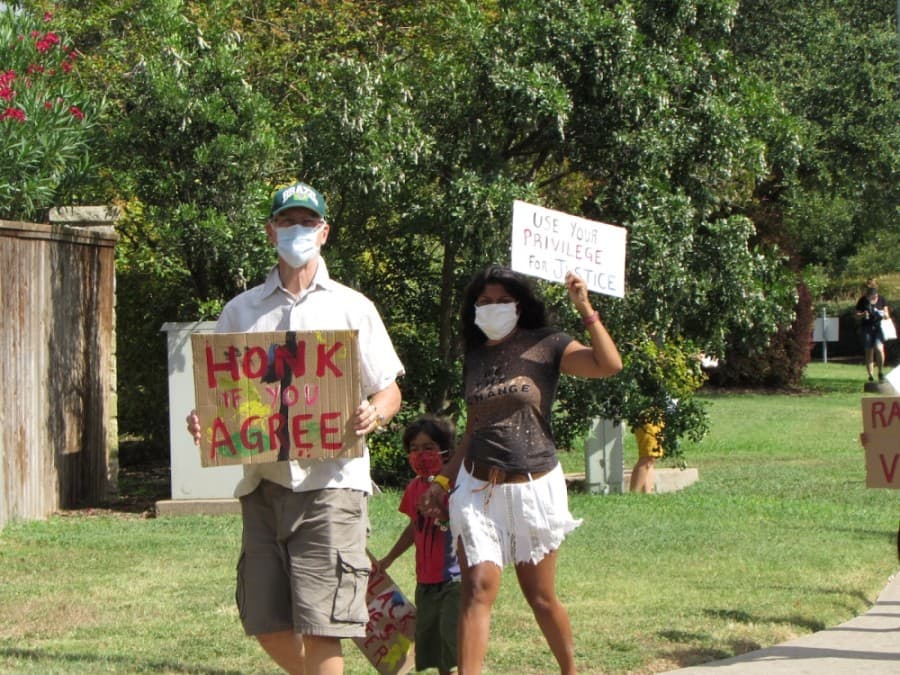 Residents held signs to support racial justice and equity. (Nicholas Cicale/Community Impact Newspaper)