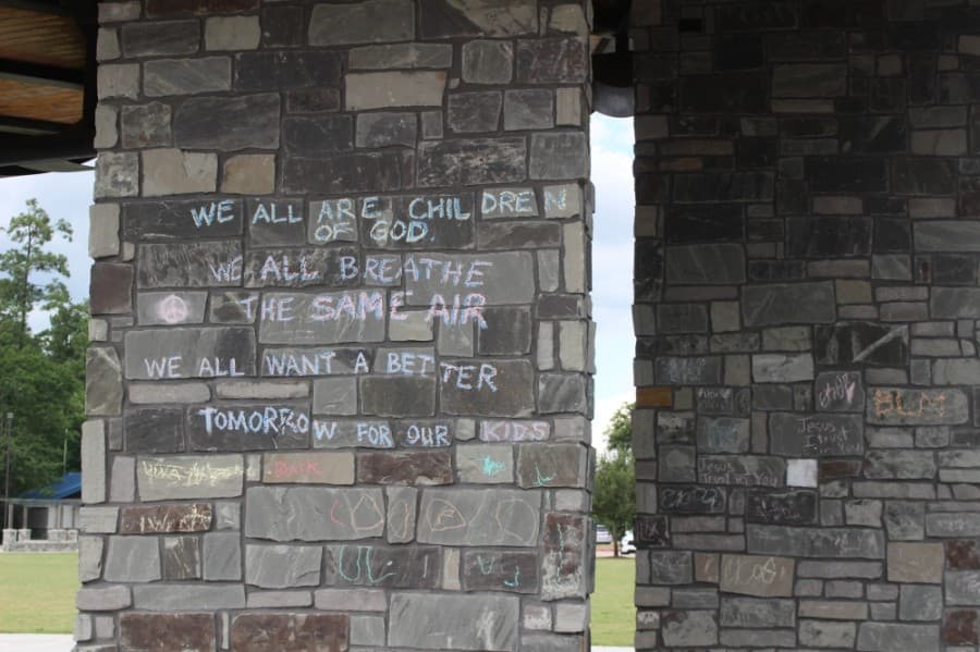 Chalk messages regarding racial justice and the Black Lives Matter movement were written on sidewalks and pavilions at Northshore Park June 19. (Ben Thompson/Community Impact Newspaper)