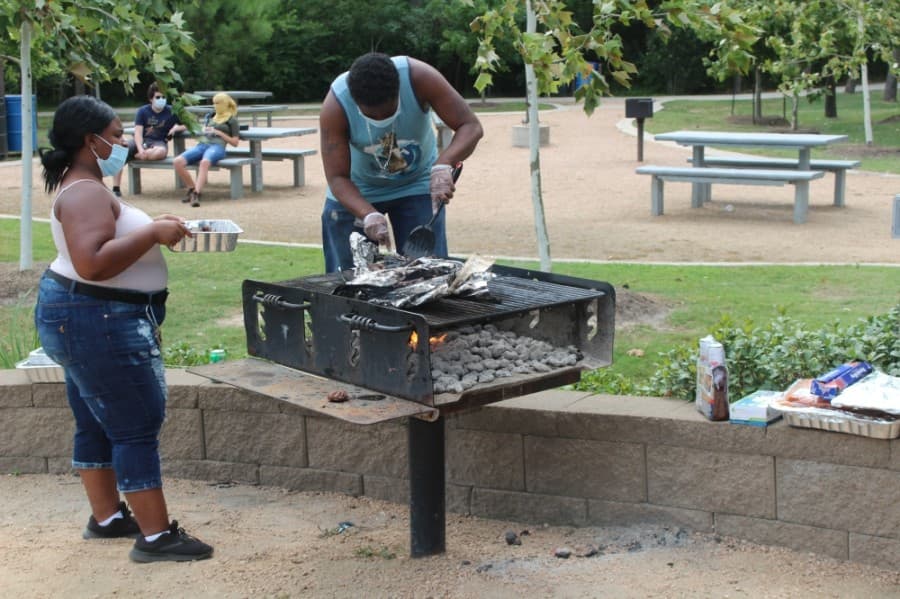 Participants at a Juneteenth event in The Woodlands began barbecuing food for attendees during the afternoon of June 19. (Ben Thompson/Community Impact Newspaper)