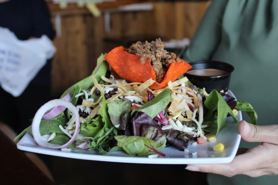 The Casa Salad ($7.99) is made with mixed greens, black beans, roasted corn, tomatoes, avocado, cheese, tortilla chips, and a choice of meat and dressing. (Ian Pribanic/Community Impact Newspaper)