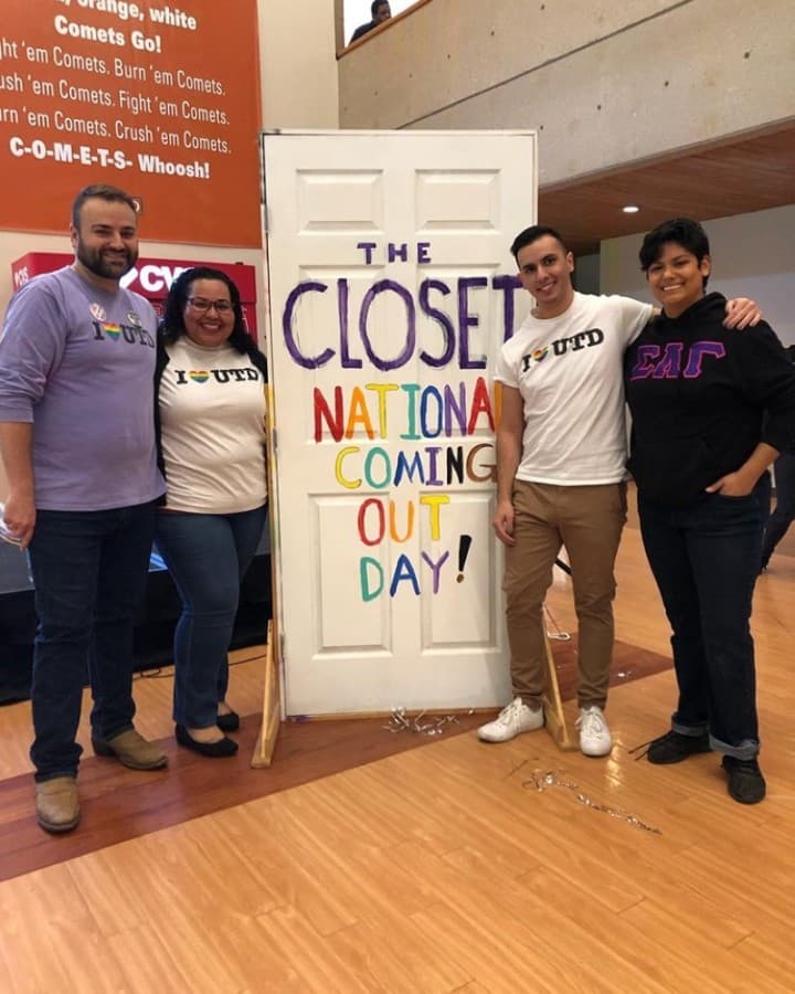 people posing in front of banner