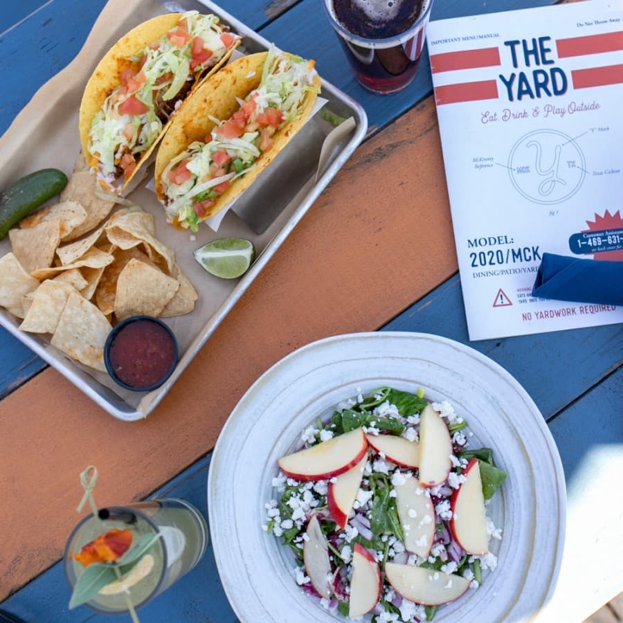 The Yard offers simpler dishes, like the Tacos Locos Supreme with a craft beer and The Backyard Mixed Green Salad with our Peach & Ginger Fizz Cocktail. (Courtesy The Yard)