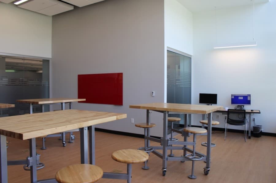 A new programming room was built in the newly added section of the library. A computer has access to editing software, and a marker board provides space for collaboration. (Miranda Jaimes/Community Impact Newspaper)
