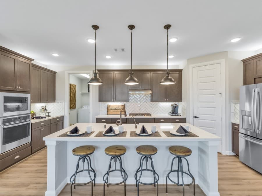 Kitchens include granite coutertops, ceramic tile flooring and backsplashes, maple cabinets and stainless steel appliances. (Courtesy Taylor Morrison)