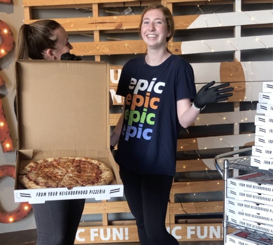 Epic Fun employees Emmaline Jasionowski (left) and Autumn Turner (right) get ready for an Epic Fun pizza giveaway in May. (Courtesy Epic Fun)