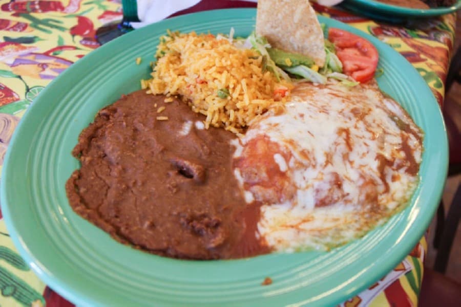 Chile relleno ($12.50): a fried poblano pepper stuffed with beef or cheese, covered with red sauce and served with rice and beans. (Kelly Schafler/Community Impact Newspaper)
