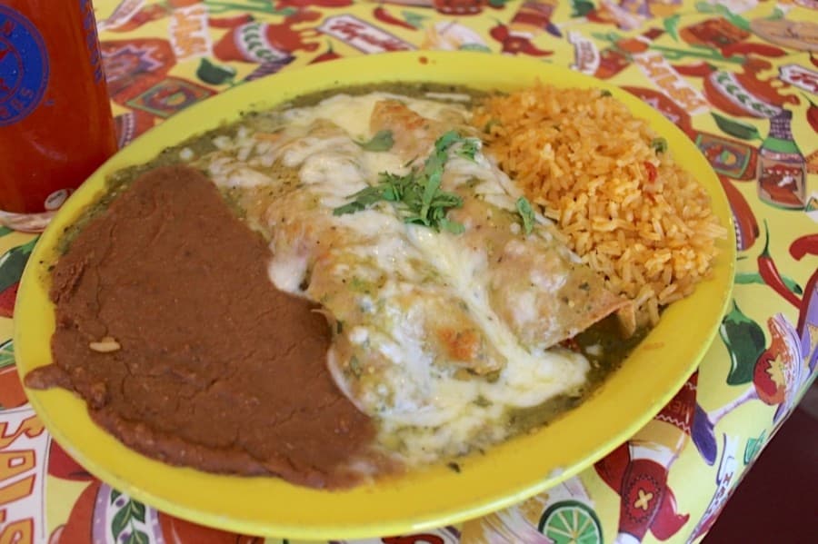 Enchiladas verdes (0-2): two or three chicken enchiladas covered in green space and served with rice and beans. (Kelly Schafler/Community Impact Newspaper)