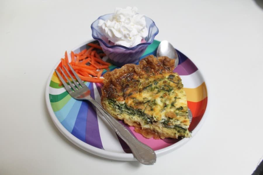 Slices of fresh quiche ($0.75) are made daily in the tea room’s kitchen and served with Berry Bliss, a frozen berry- and yogurt-based treat. (Jake Magee/Community Impact Newspaper)