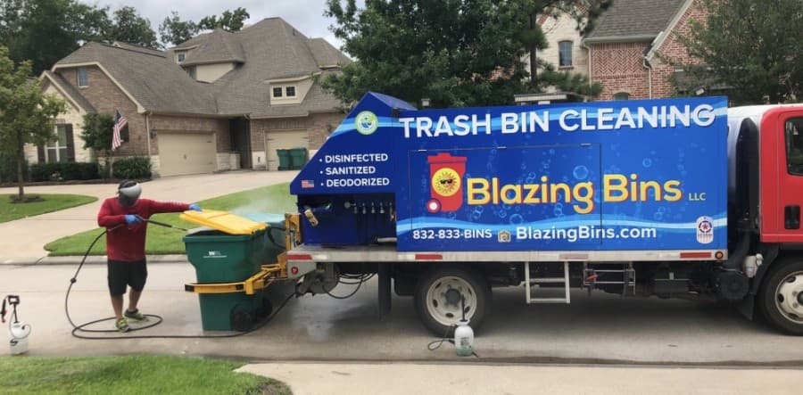Richard Shubin cleans a pair of trash bins with the company’s custom truck. (Courtesy Blazing Bins)