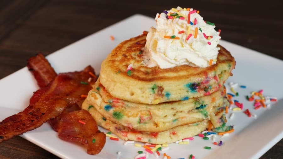 The sweet stack of It's Your Birthday Cake Pancakes ($9.95) is made with cake batter and topped with cake batter whipped cream. Available with bacon or sausage ($1) or ham $1.55). (Courtesy Raydon Creative)