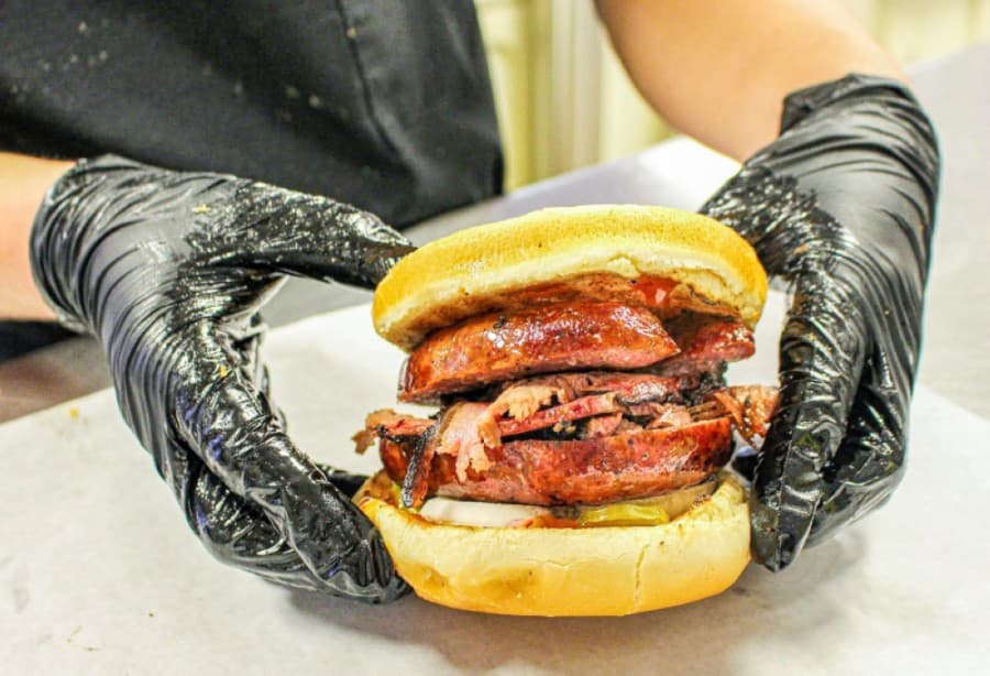 The restaurant has become known for its sandwiches, including The Buddy, which features brisket, sausage, pickles and onions. (Courtesy San Marcos BBQ)