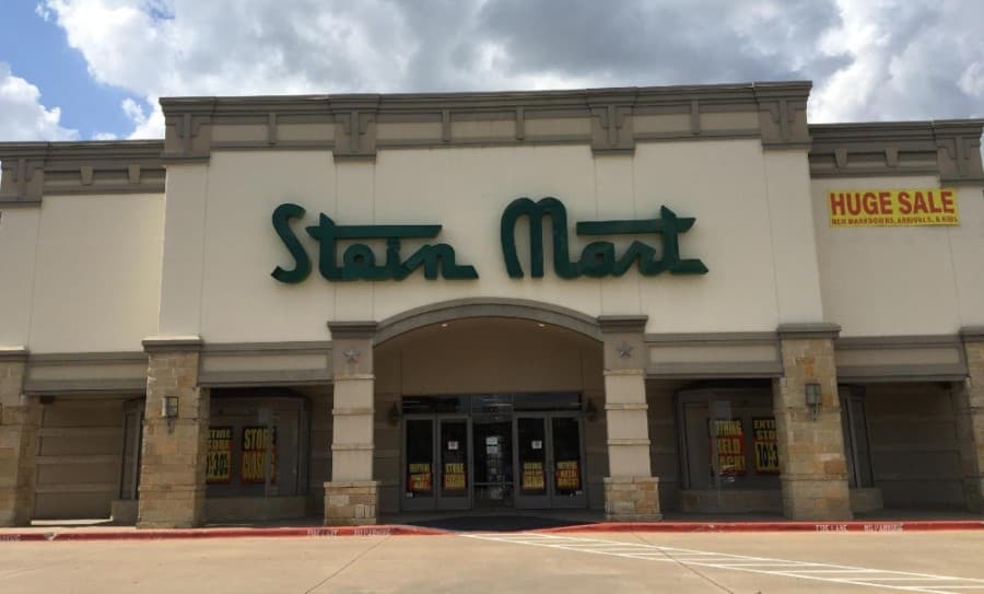 Signs in the window of the Stein Mart store in Frisco state it will be among the locations closing as part of the company's liquidation process. (Valerie Wigglesworth/Community Impact Newspaper)
