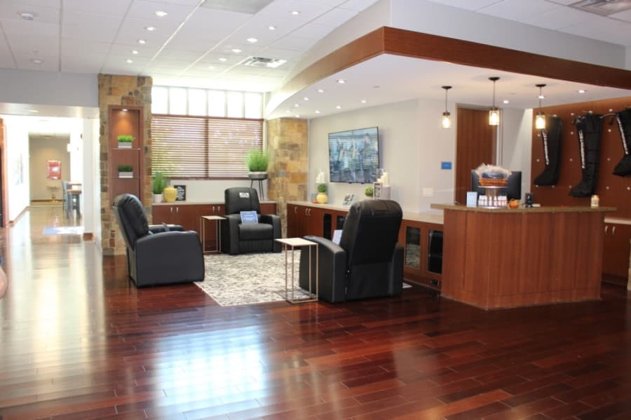 This area of Craig Ranch Fitness & Spa is new following recent renovations, with chairs that use compression to stimulate blood flow rather than cardio machines. (Miranda Jaimes/Community Impact Newspaper)
