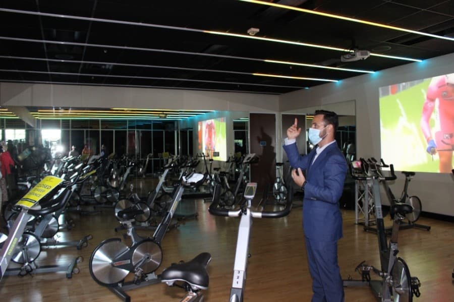 Changes have been made to the cycling studio at Craig Ranch Fitness & Spa, such as lighting and a 15-foot screen. (Miranda Jaimes/Community Impact Newspaper)