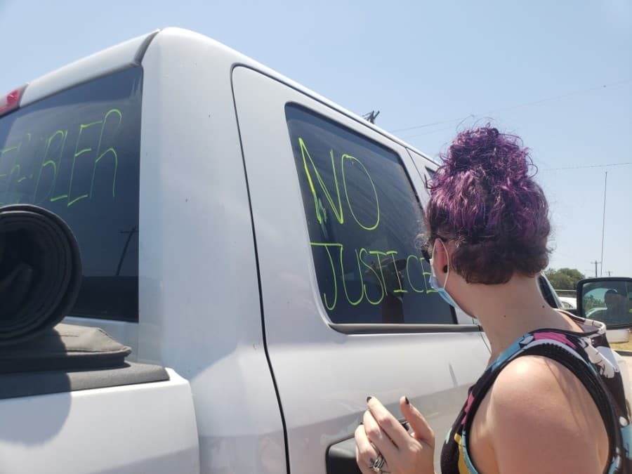 Raven Nicholetto decorated her car with the phrase "No Justice, No Peace" for the Pushing for Justice Caravan for Javier Ambler on Aug. 15. (Ali Linan/Community Impact Newspaper)