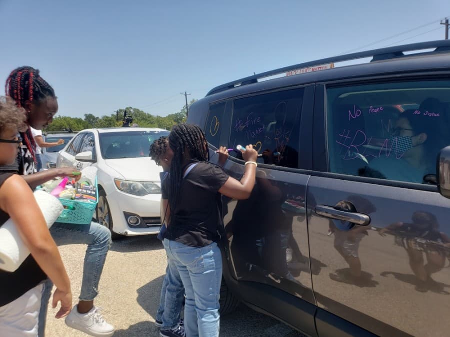Kids helped decorate cars for the Pushing for Justice Caravan for Javier Ambler on Aug. 15. (Ali Linan/Community Impact Newspaper)