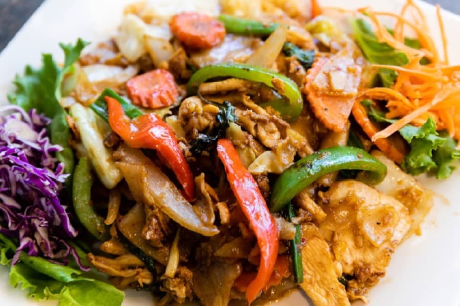 Drunken Noodles with Beef ($12.95) is a dish made with flat noodles and egg, onion, cabbage, carrot, fresh basil and bell peppers in a Thai chili sauce. (Courtesy Taste of Thai)