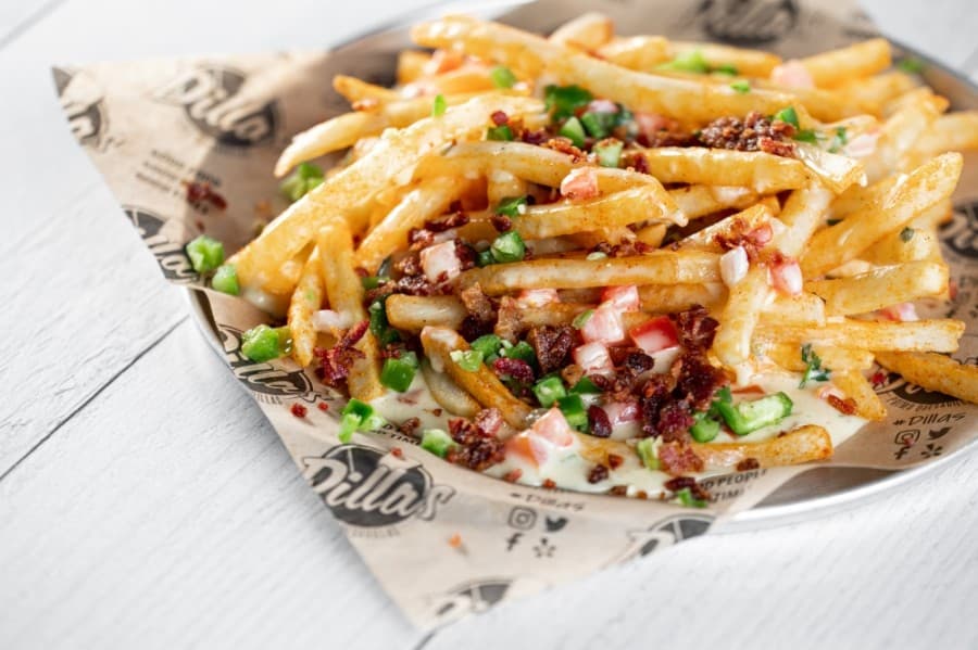 Gorilla fries come with Hatch chile queso. Bacon and jalapeños are available as toppings. (Courtesy Dillas Primo Quesadillas)