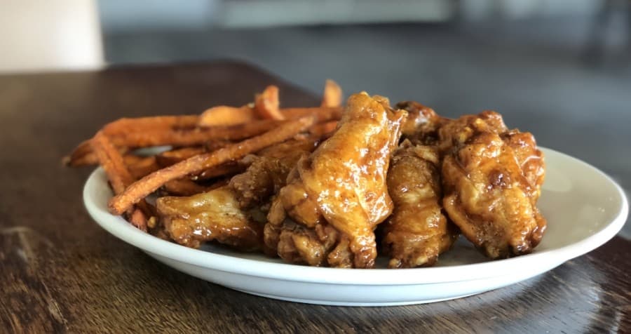 Chicken wings with a variety of sauce options are available as an appetizer. (Courtesy Kitchen 1488)