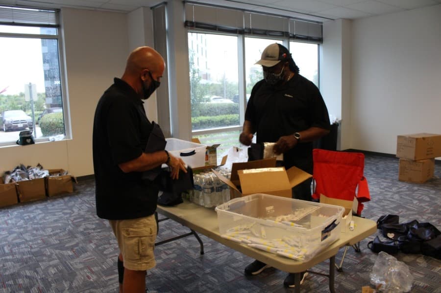 Randy Copeland (left) and Alphonso Williams (right) from CoServ joined the packing event Sept. 1. (Elizabeth Uclés/Community Impact Newspaper)