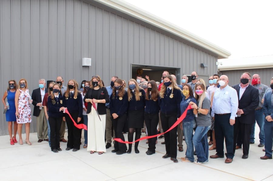 Tomball ISD officials, board members, students and community members celebrated the completion of the Tomball High School Agricultural Science Project Center, located behind the high school, with a ribbon cutting ceremony Sept. 4. (Anna Lotz/Community Impact Newspaper)