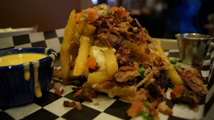 Liberty Barbecue’s Trash Fries are a restaurant staple, a plate of french fries doused in brisket, mozzarella, bacon and pico de gallo. (Kelsey Thompson/Community Impact Newspaper)