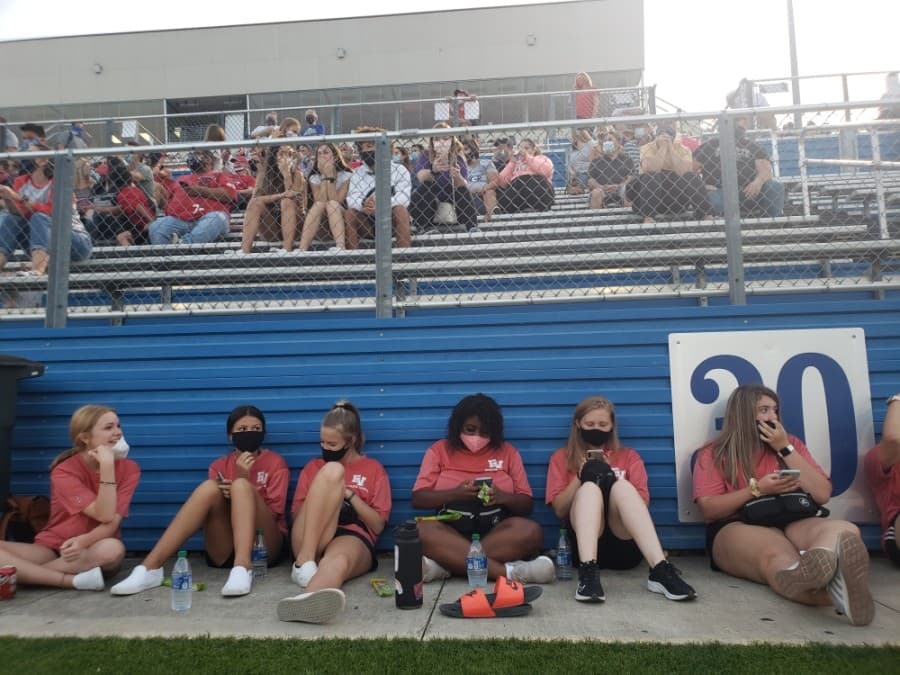 Student trainers sit along the side of the field during a Georgetown versus East View High School scrimmage game Sept. 18. (Ali Linan/Community Impact Newspaper)
