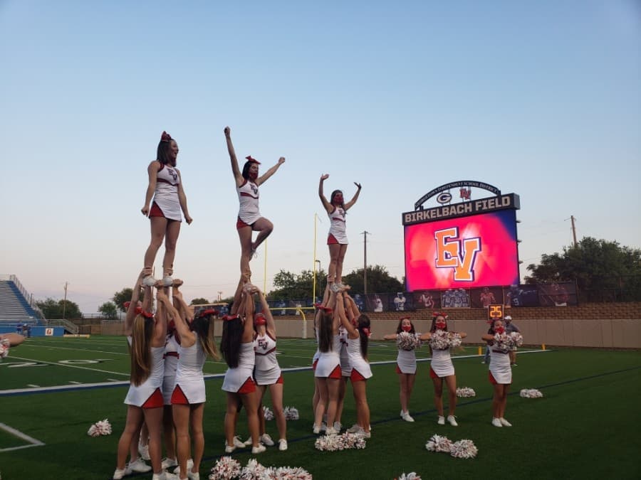 East View High School student cheerleaders cheer on the sidelines during a Sept. 18 scrimmage game. (Ali Linan/Community Impact Newspaper)