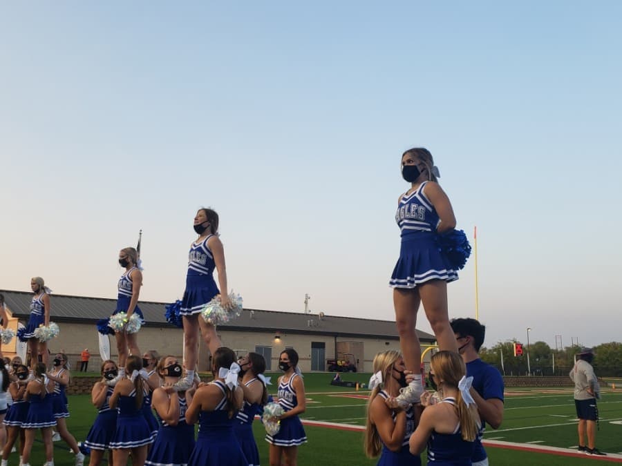 Georgetown High School student cheerleaders cheer on the sidelines during a Sept. 18 scrimmage game. (Ali Linan/Community Impact Newspaper)