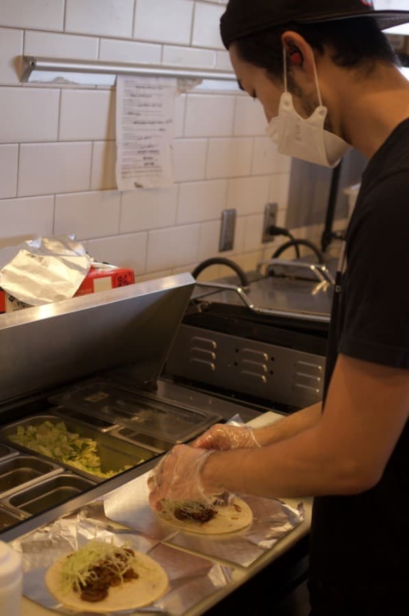 Owner and chef Jason Choi prepares tacos that combine the strengths of Korean and Mexican cuisine. (Warren Brown/Community Impact Newspaper)