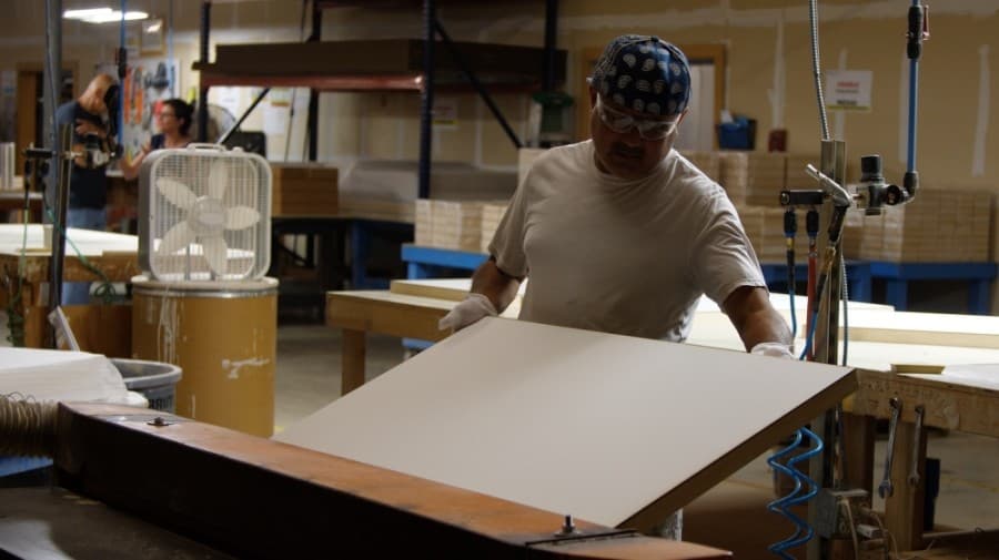 An Ampersand employee helps create a surface panel at Ampersand's facility. (Courtesy Jon Williams)